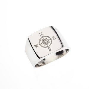 Square silver signet ring with engraved Compass symbol.