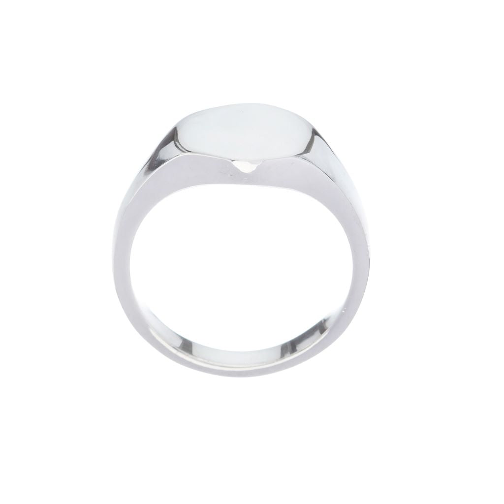 Oval silver signet ring with engraved Fleur de Lis symbol.