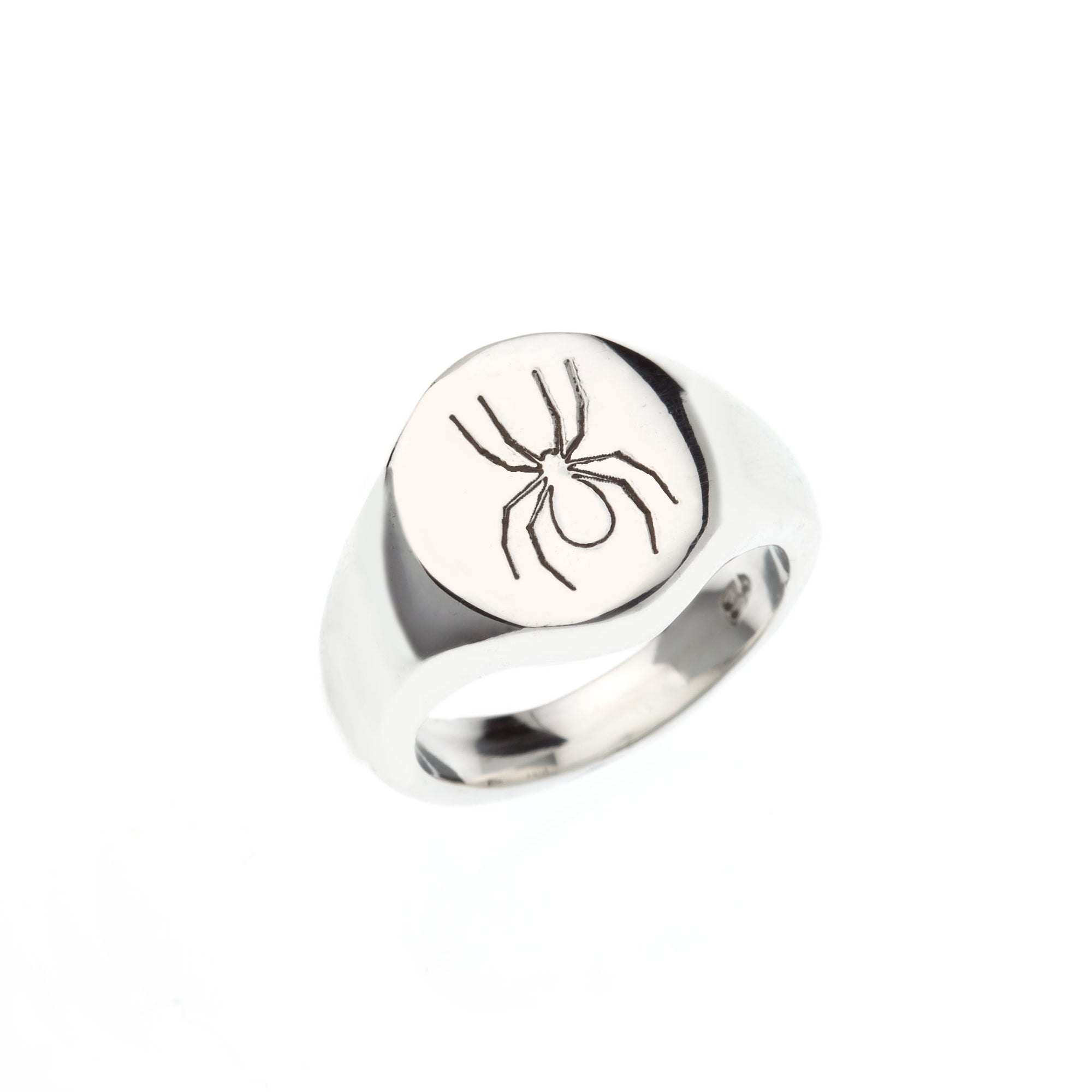 Oval silver signet ring with engraved spider symbol.